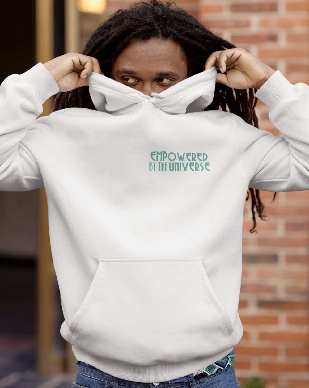 man playing wearing Empowered by the Universe white pullover hoodie