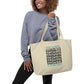 woman holding Empowered by the Universe eco tote bag large oyster